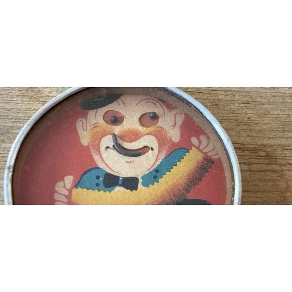 Vintage hand held dexterity puzzle clown playing accordian mirror back Japan 2
